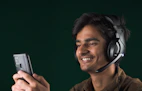 Smiling customer service representative wearing a headset, ready to assist.