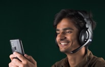A close-up of a customer service representative wearing a headset, smiling while assisting a client.