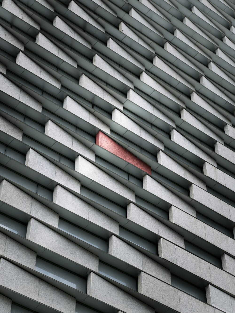 a red object is sticking out of the side of a building