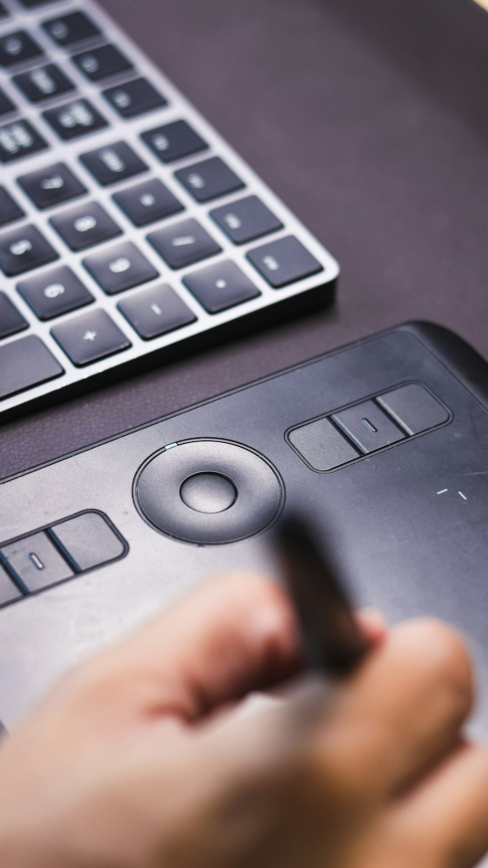 a person using a pen to write on a tablet