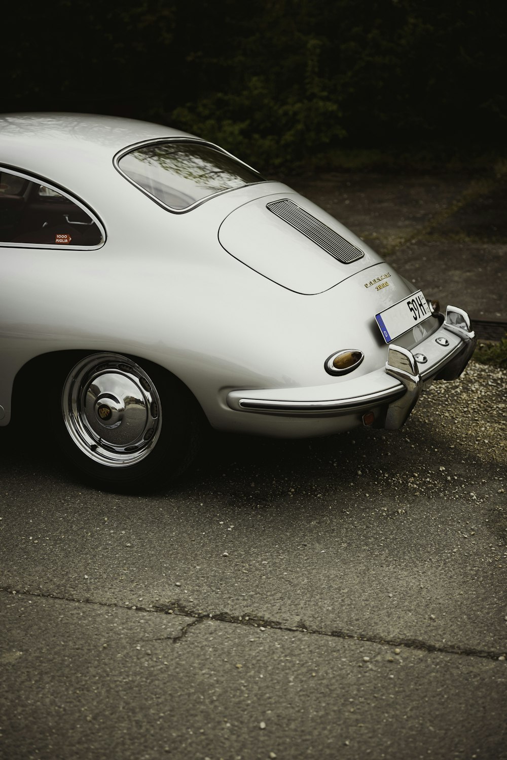 a white sports car parked on the side of the road