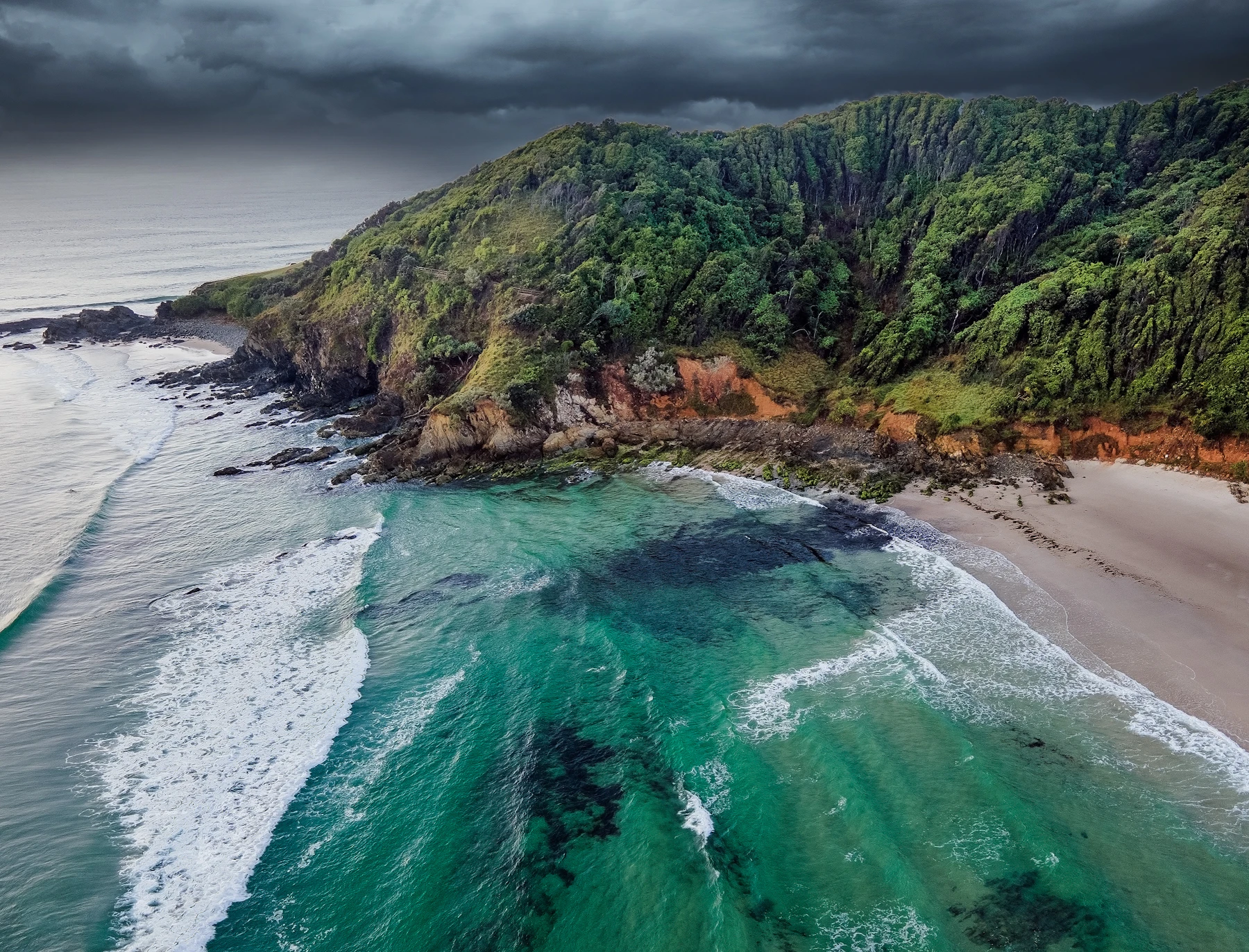 Aerial view of surf lines and breaking waves along a beach