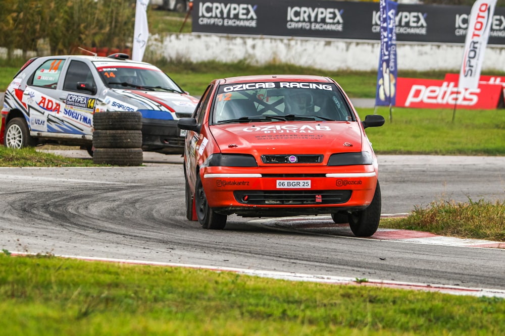 a red car driving down a race track