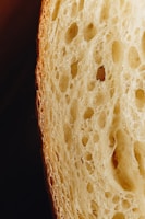 Close-up of a traditional Minas Gerais cheese bread being pulled apart, showing its gooey inside.