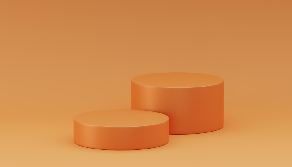 a pair of orange stools sitting on top of a brown floor
