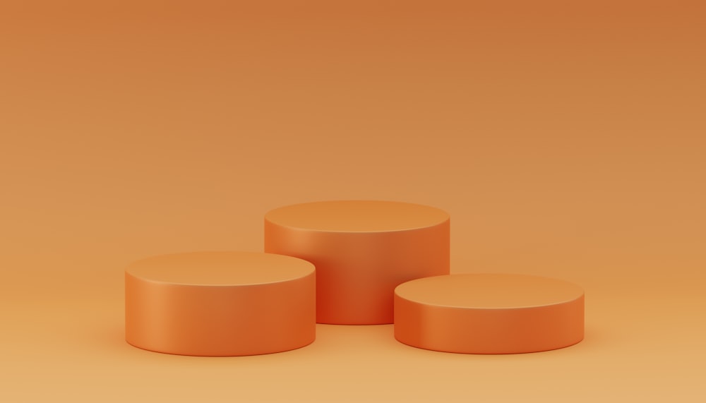 three round stools on an orange background