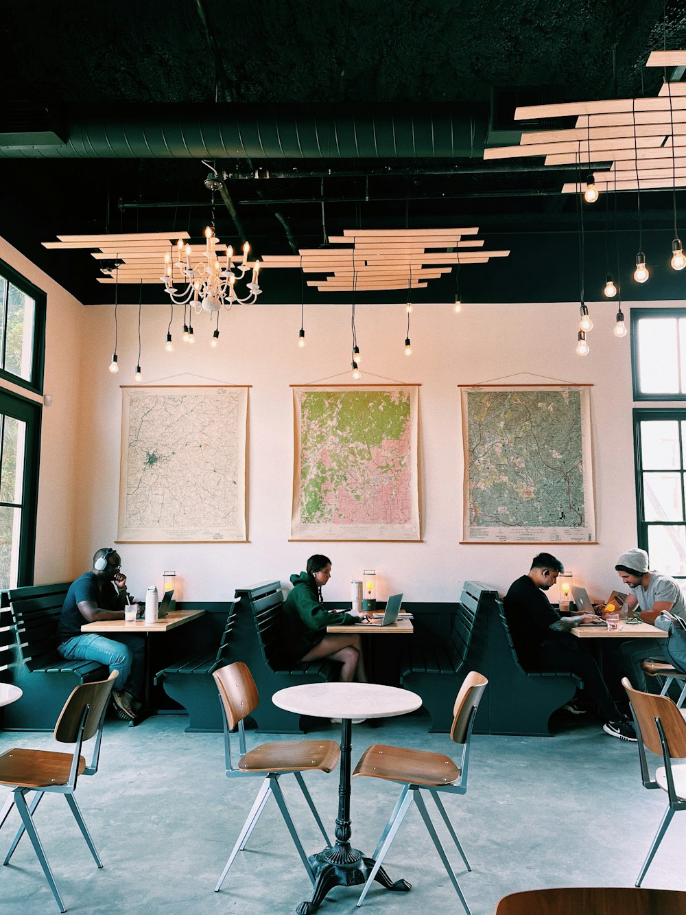 a group of people sitting at tables in a restaurant