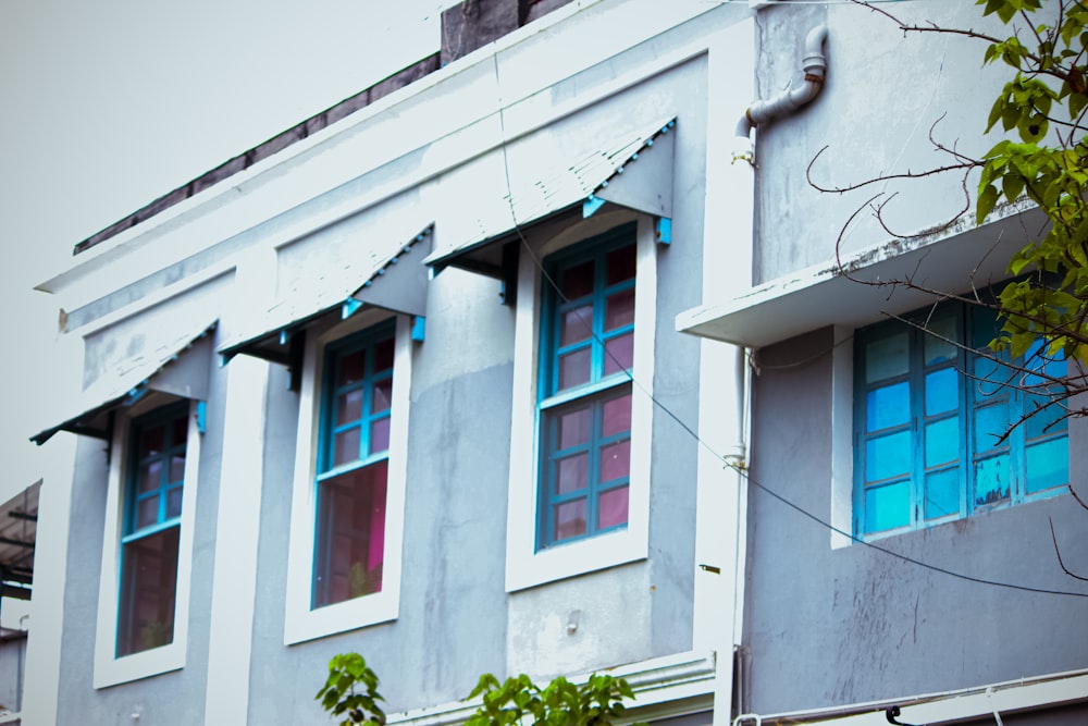 a blue and white building with a clock on the side of it