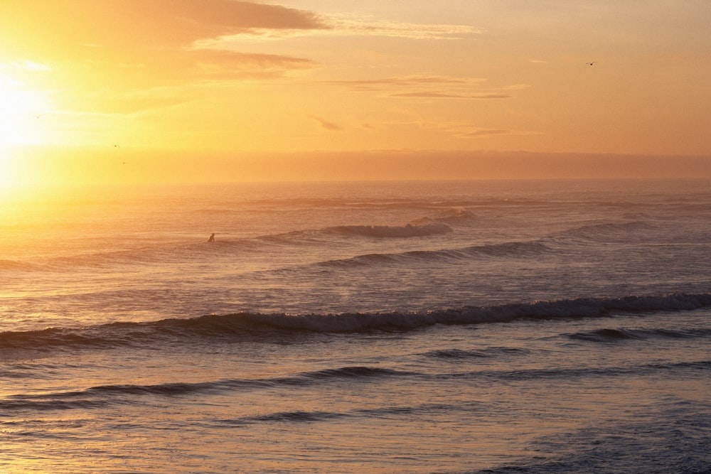 a person riding a surfboard on a wave in the ocean