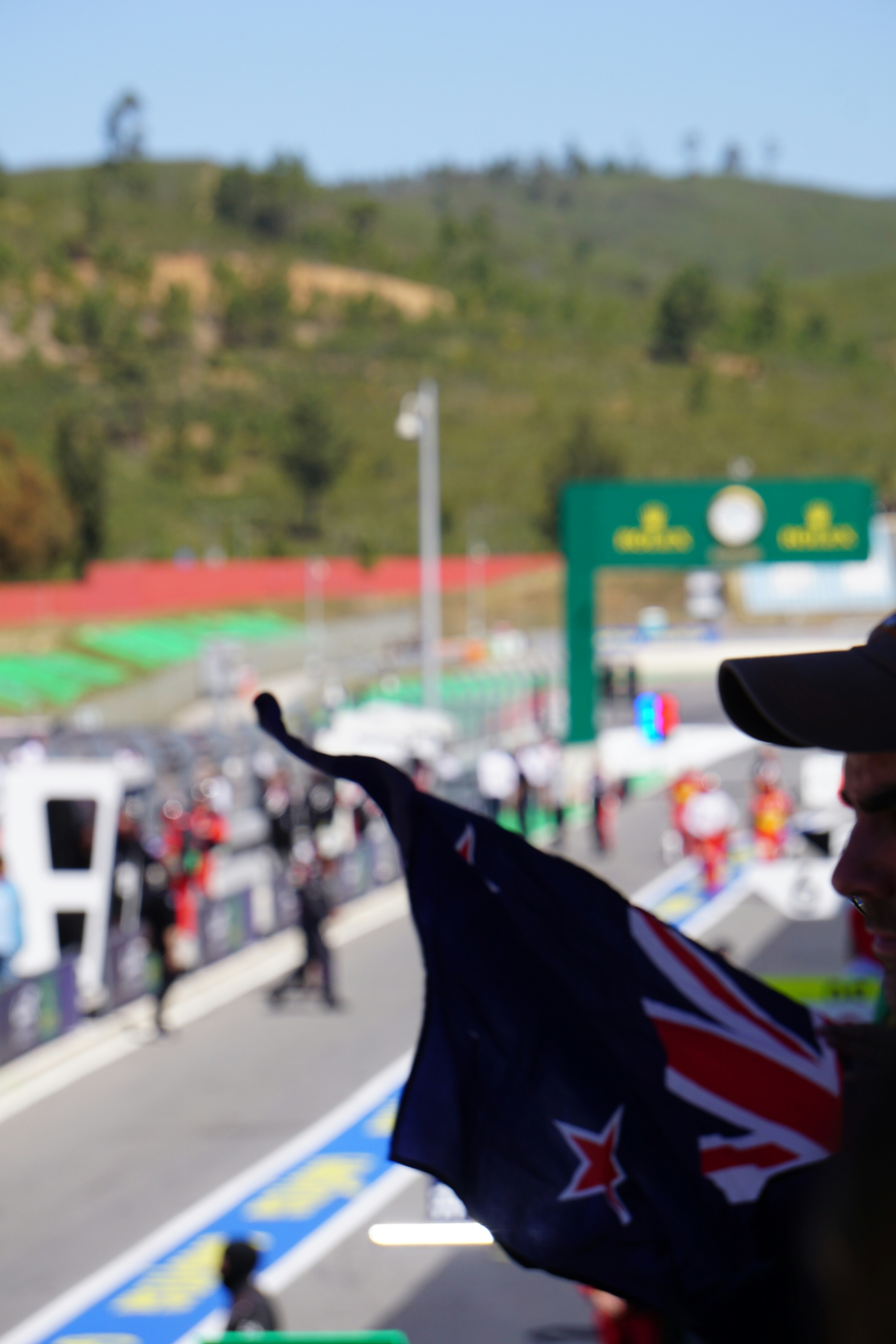 a man holding a flag on a race track