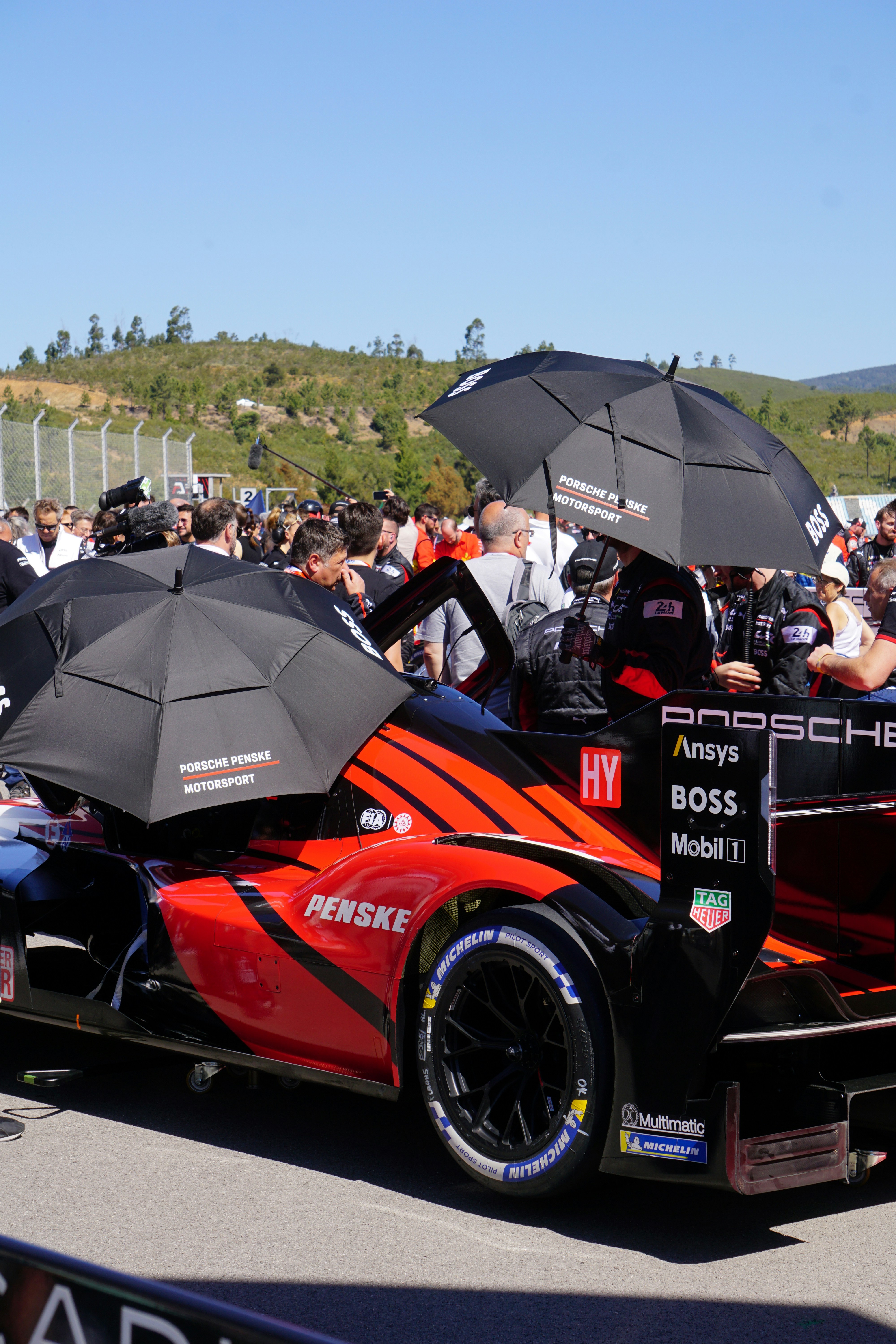a race car with umbrellas on top of it