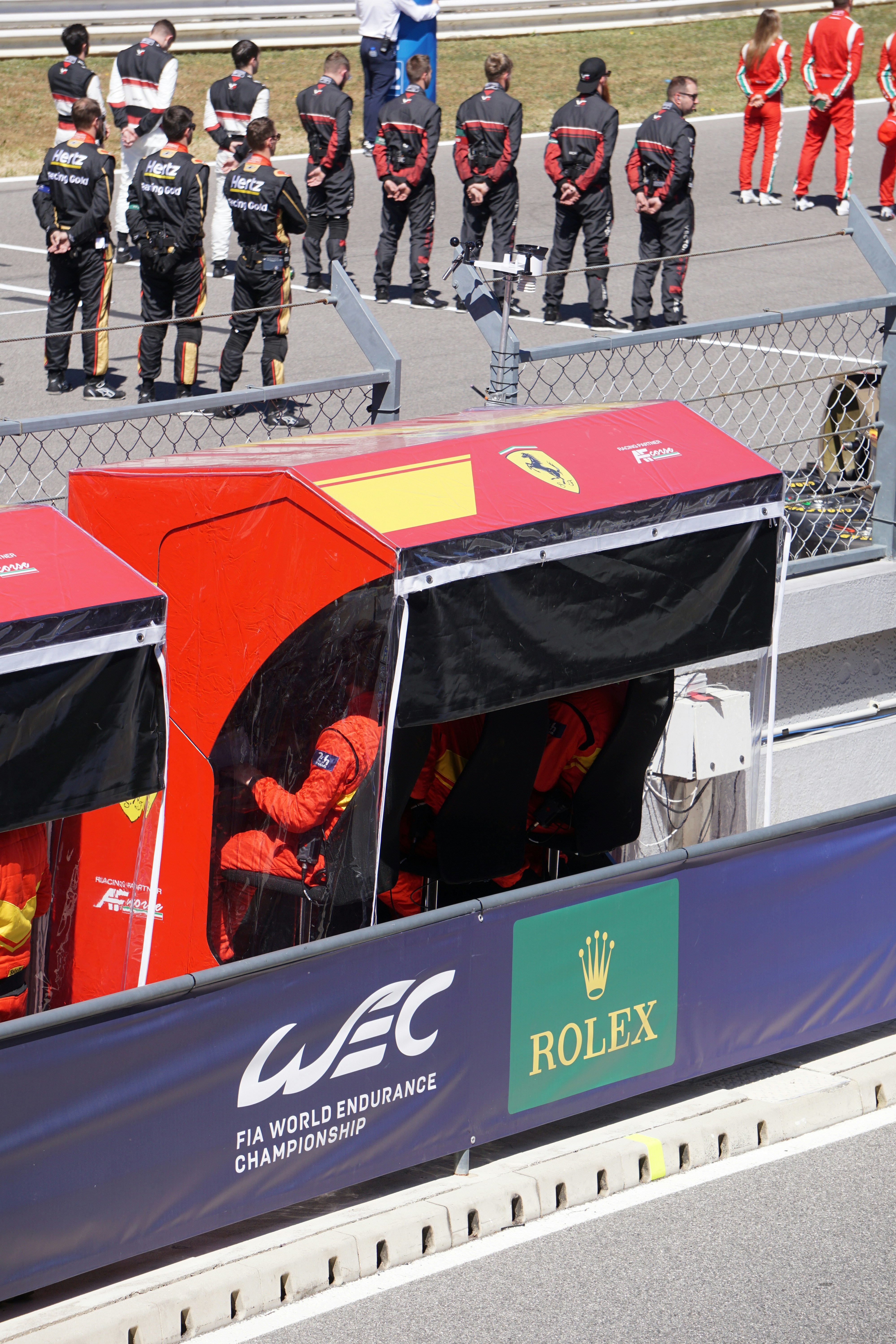 a group of people standing around a race track