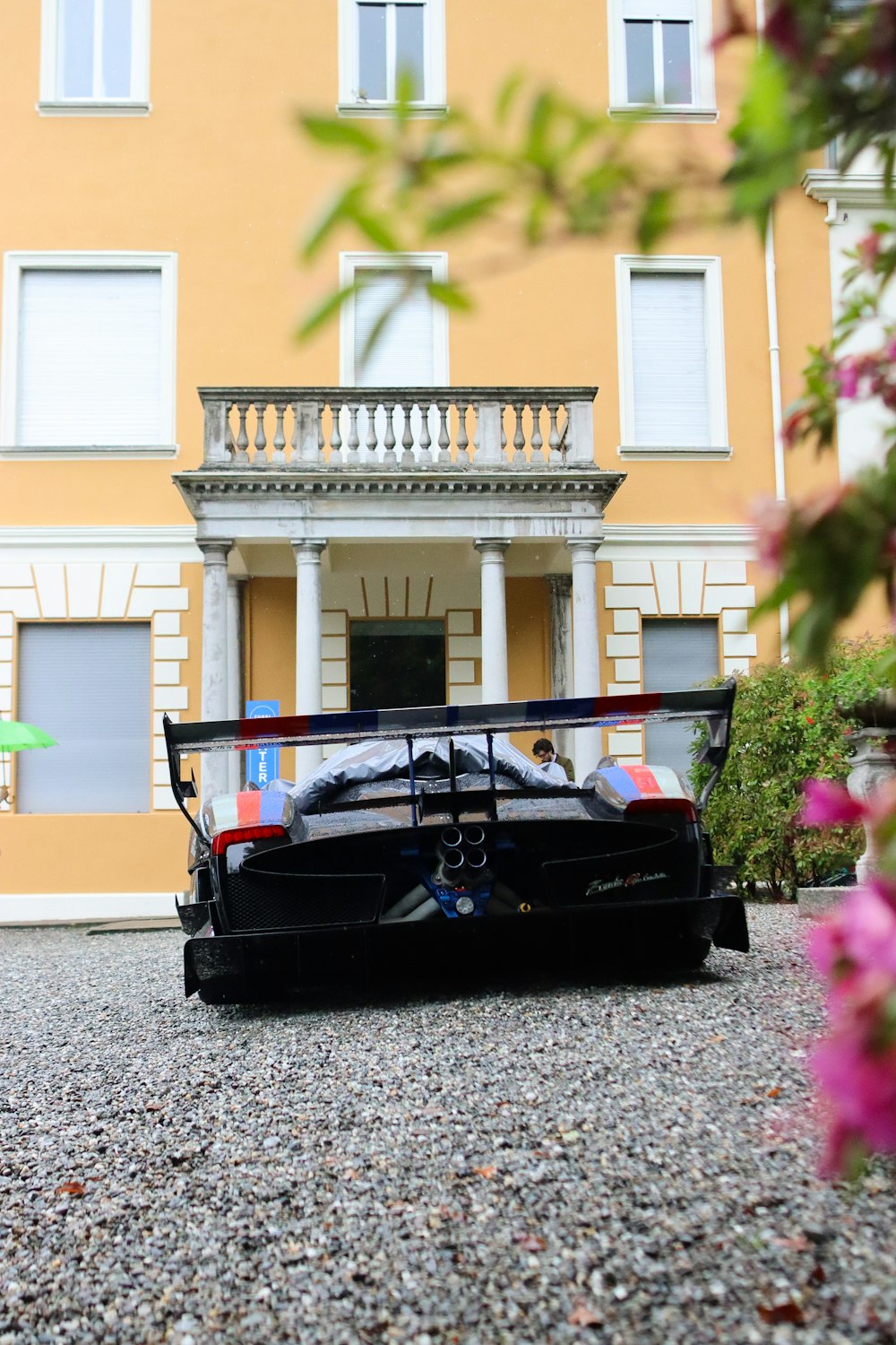 a black sports car parked in front of a building