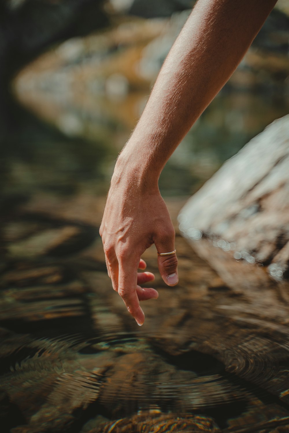 a person reaching for something in the water