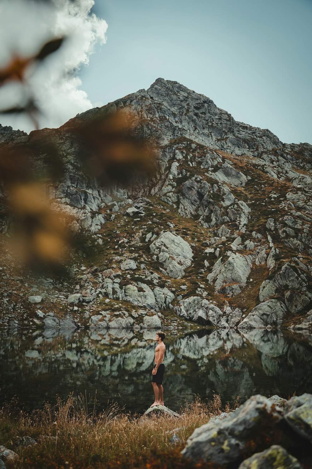 a man standing on top of a rocky hill