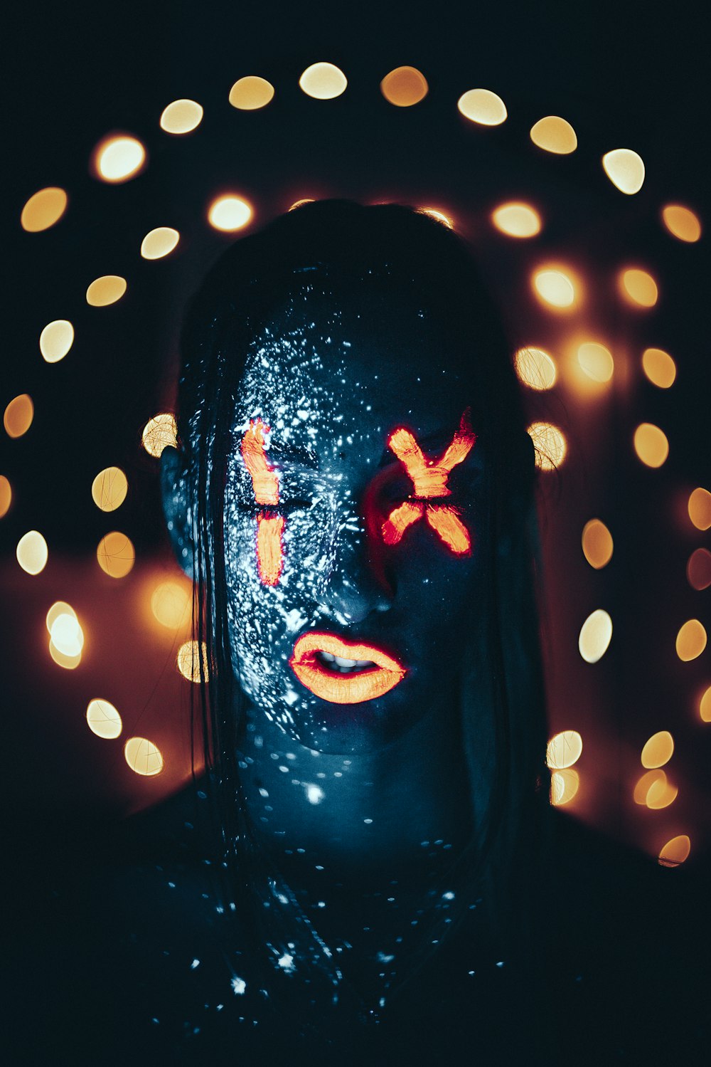 a woman's face is covered in lights