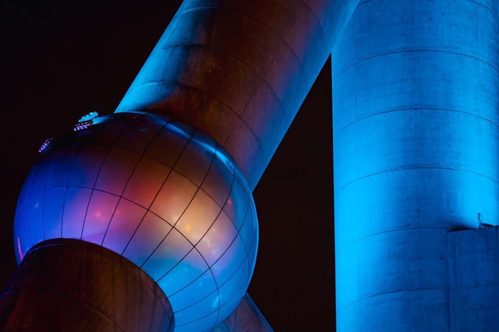 a very tall building with a very colorful light on it's side