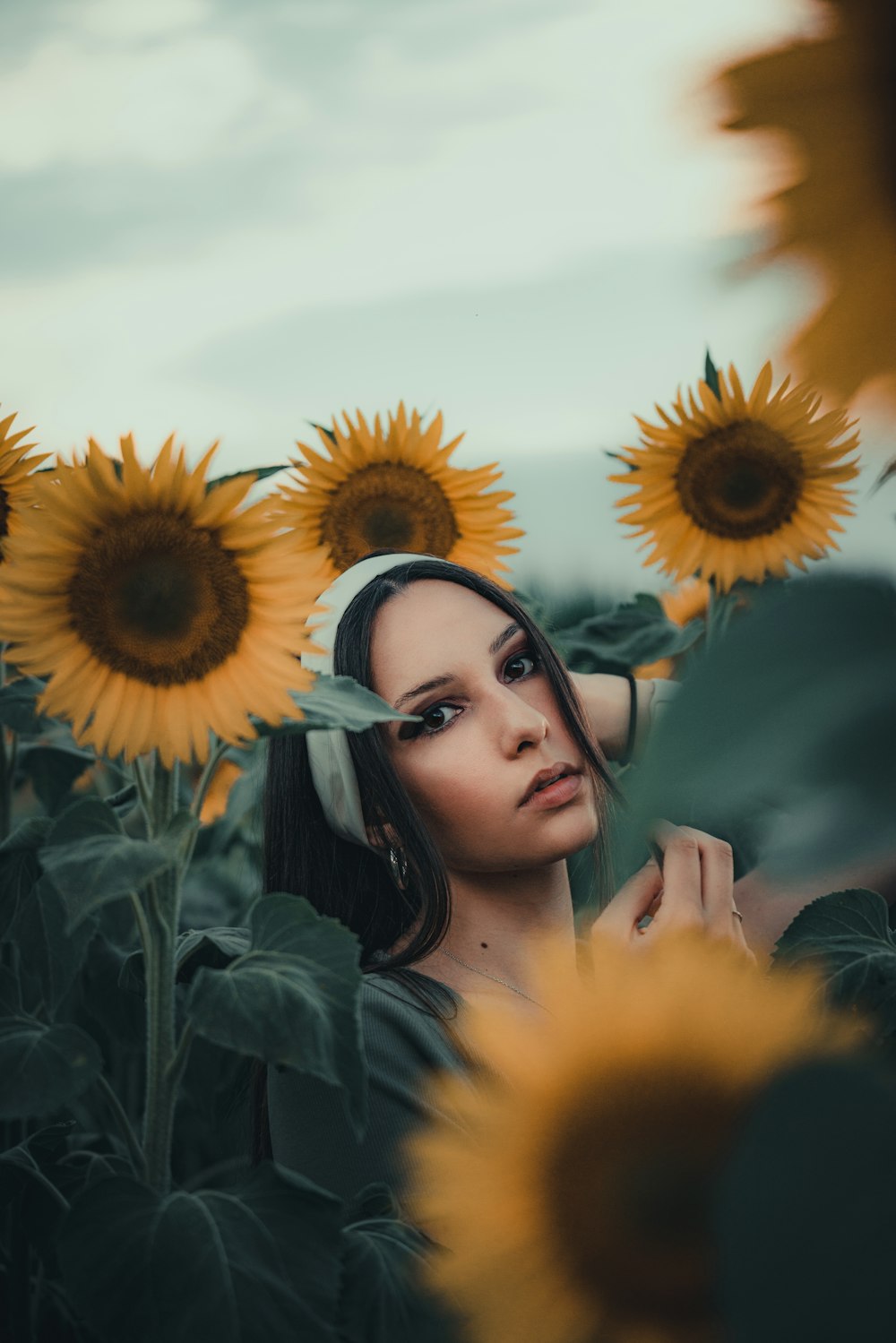 a woman standing in a field of sunflowers