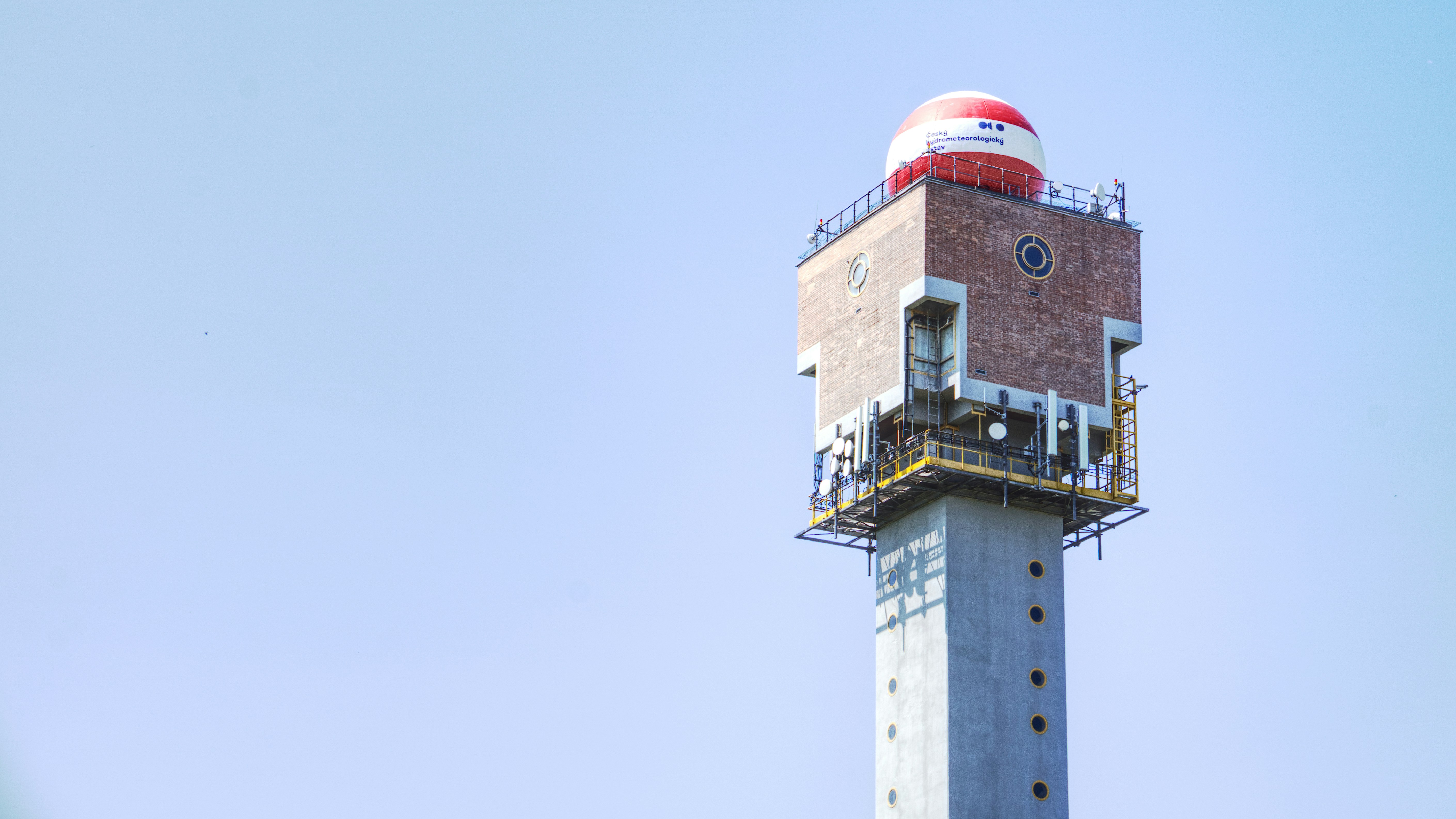 a tall tower with a red and white top