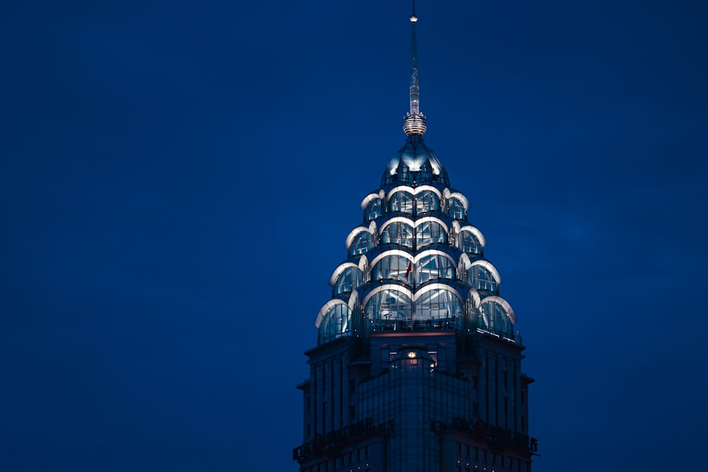 the top of a building lit up at night