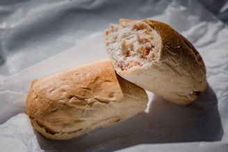 Top-down view of a BBQ bacon chicken melt sandwich cut in half, showcasing the hearty filling