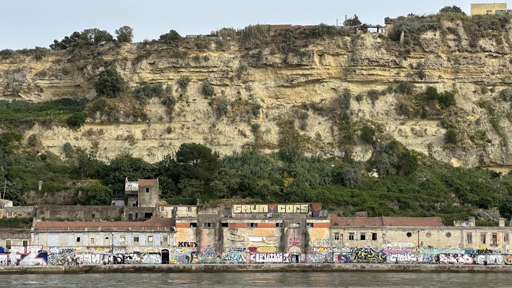 a building with graffiti on the side of a cliff