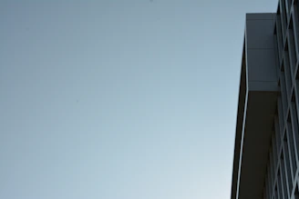 Close-up shot of a minimalist building facade featuring sharp lines under moody lighting.