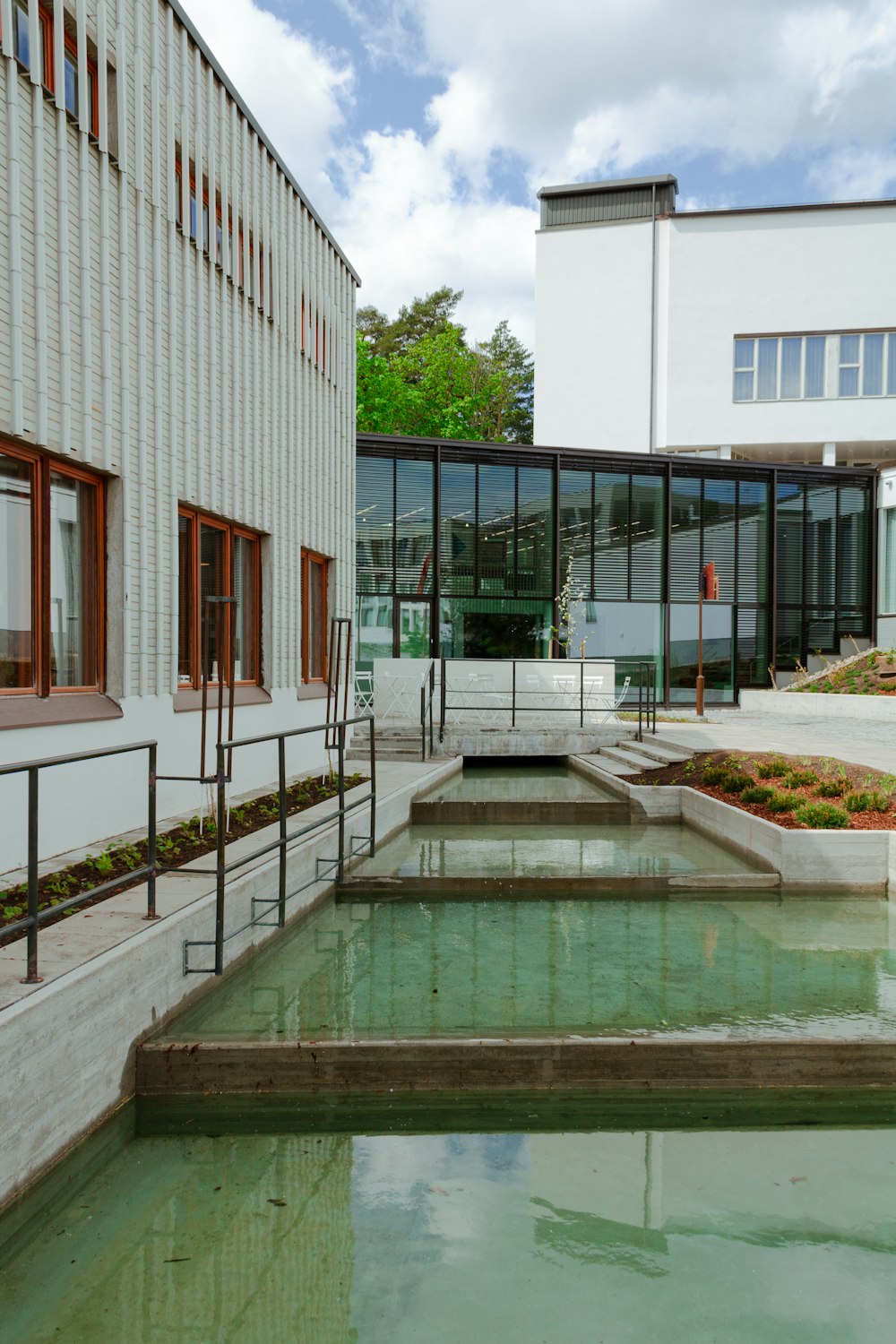a building with a water feature in front of it