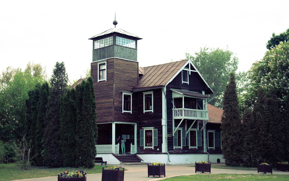 a large brown house with a clock tower