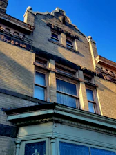 A close-up of an old, beautifully restored brick building with vintage architectural details on South Flower Street.