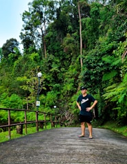 A confident person standing at a crossroads surrounded by nature.