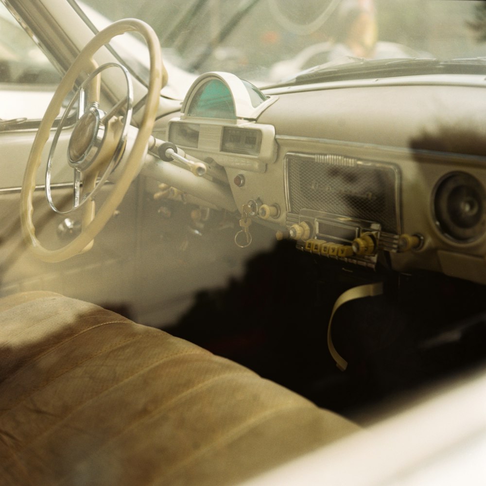 the interior of a car with a steering wheel and dashboard