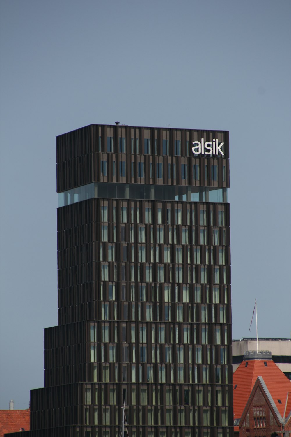 a tall building with a sign on top of it