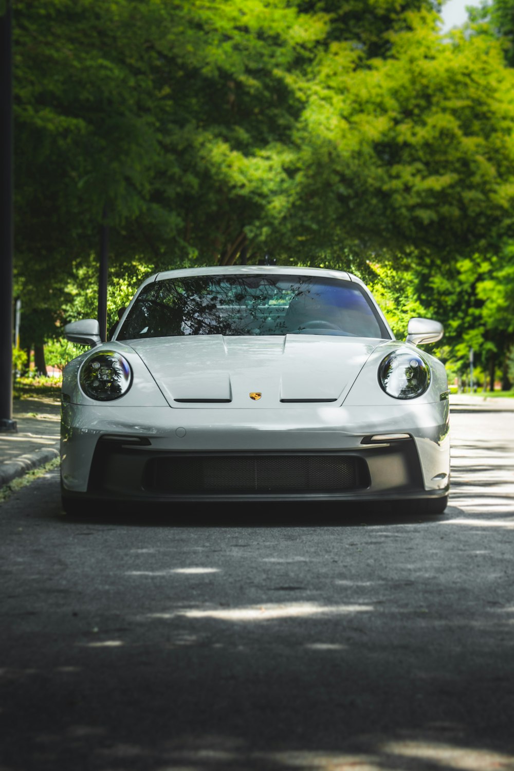 a white sports car parked on the side of the road