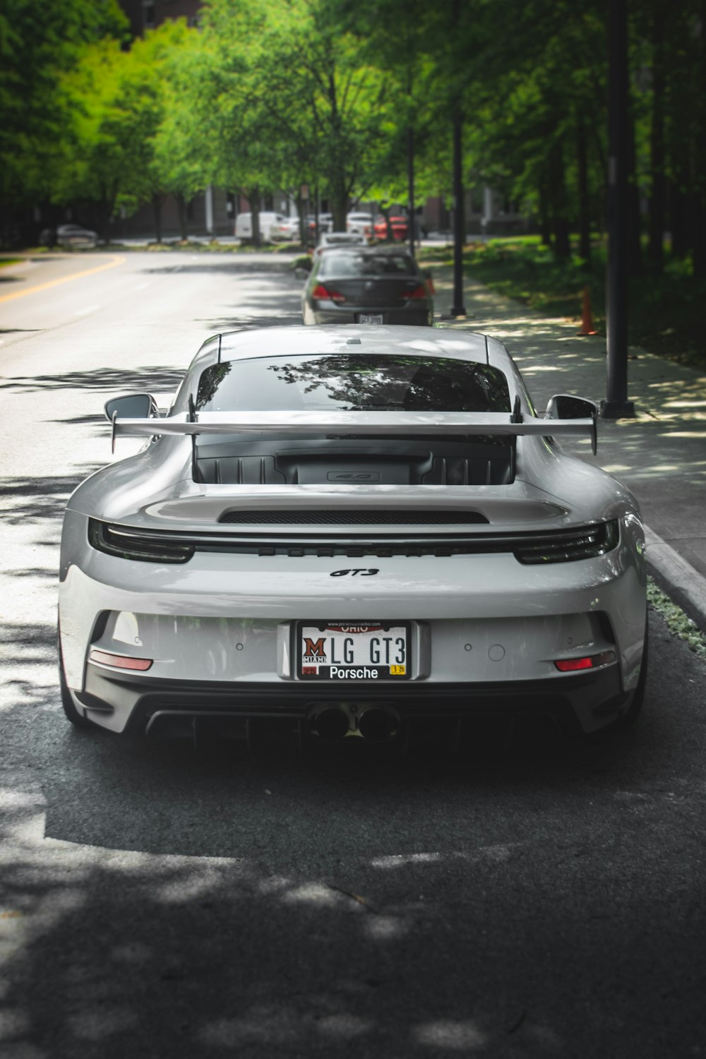 a white sports car parked on the side of the road