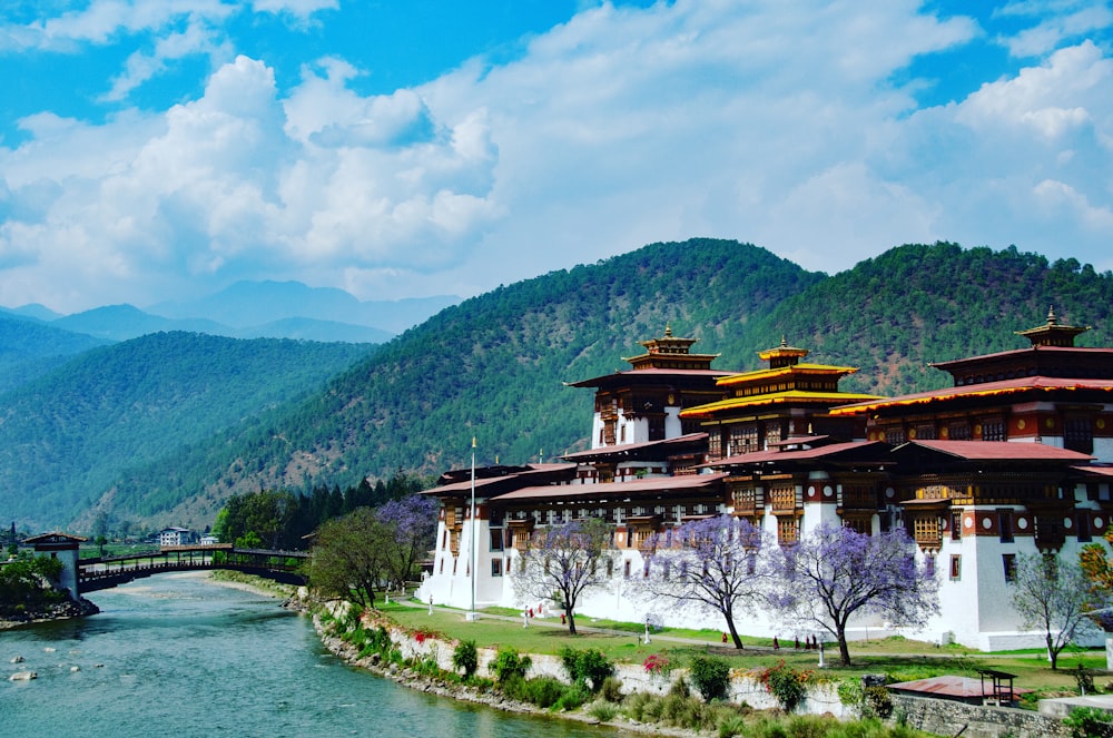 a large building sitting on top of a lush green hillside