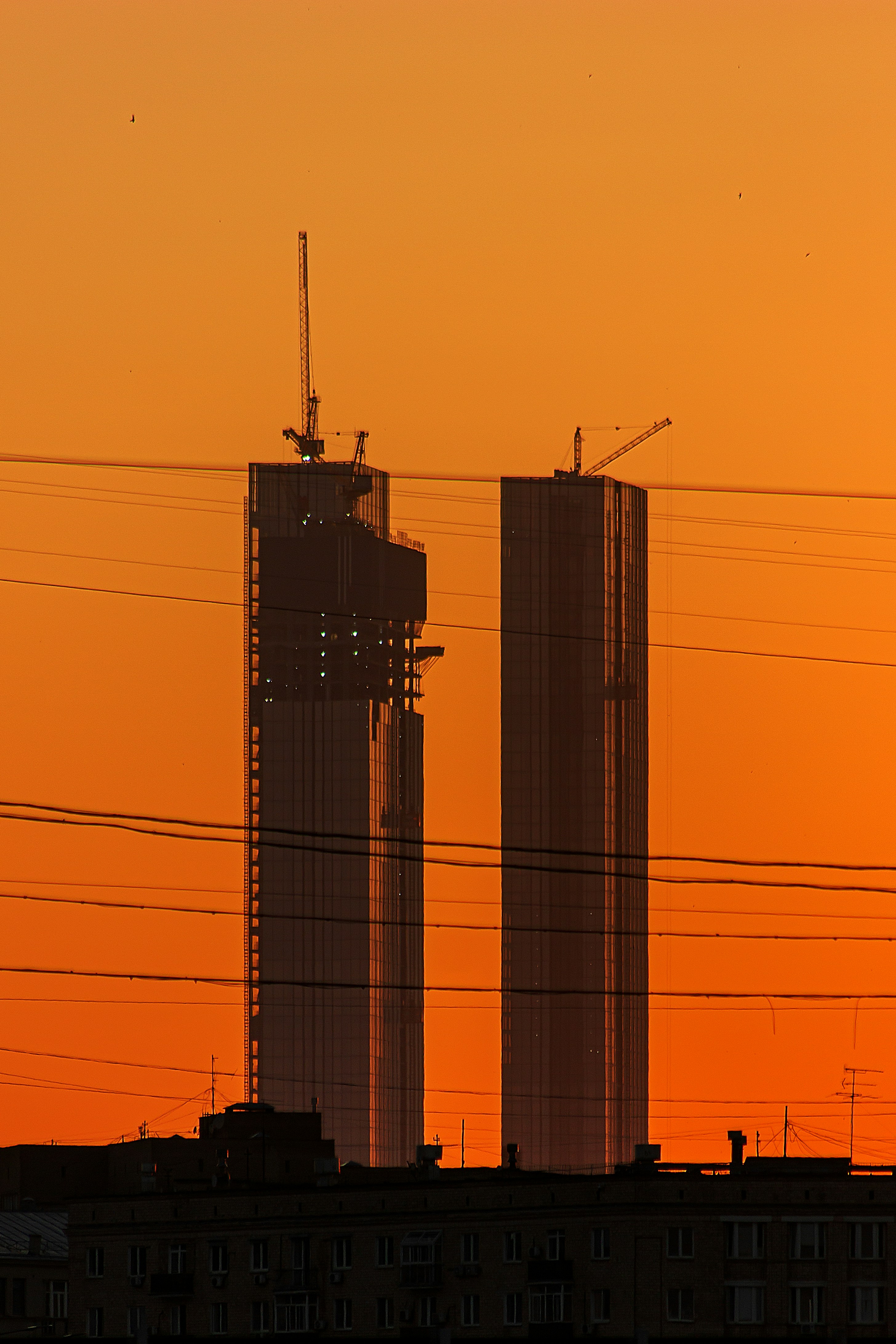 a couple of tall buildings sitting next to each other