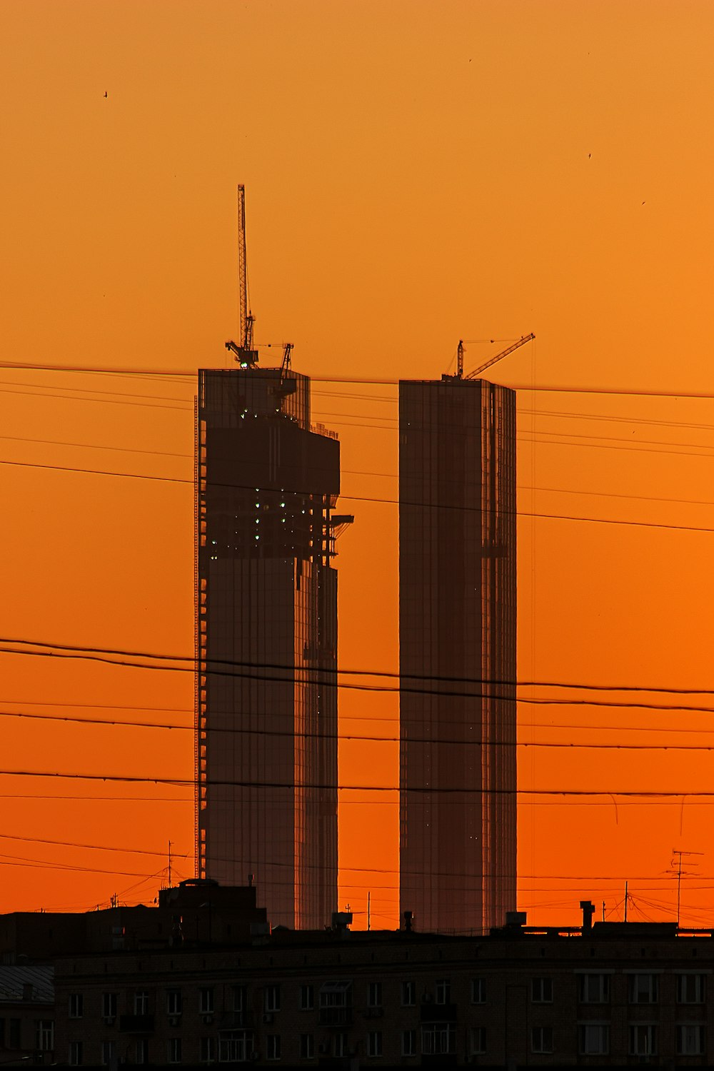 a couple of tall buildings sitting next to each other