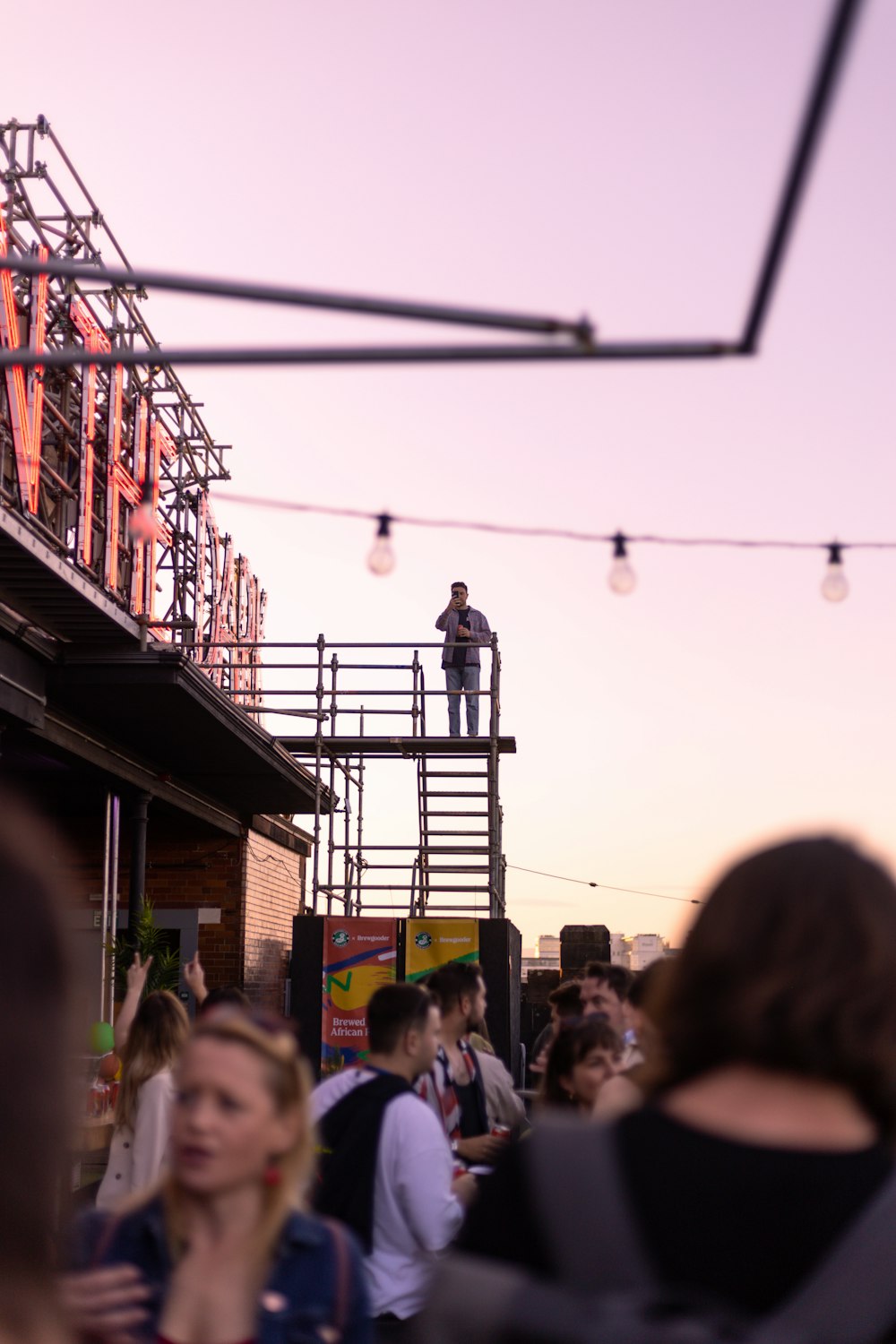 a group of people standing on top of a building