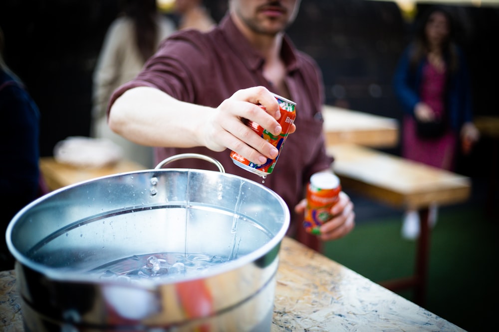 a man holding a can of soda in his hand