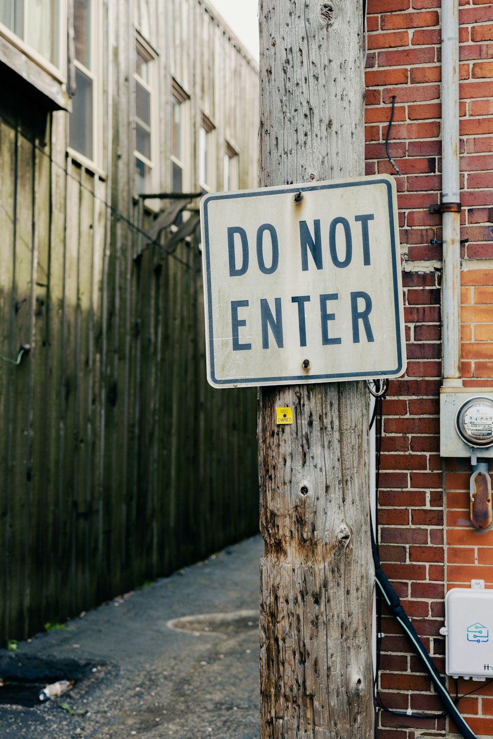 a do not enter sign attached to a telephone pole