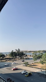 A group of vintage American cars cruising through scenic countryside roads in Maine et Loire.