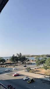 A group of vintage American cars cruising through scenic countryside roads in Maine et Loire.