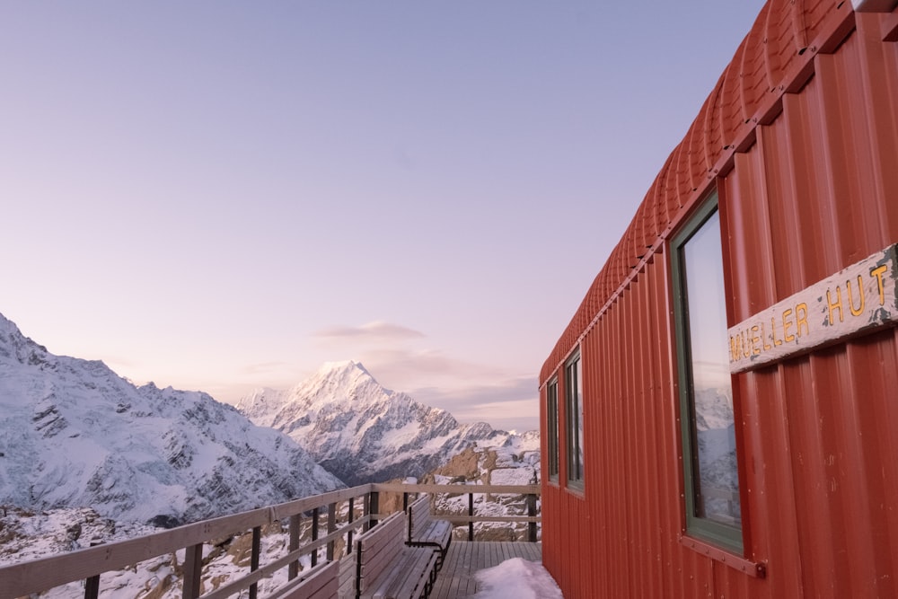 a red building sitting on top of a snow covered mountain