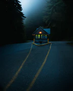 A sturdy wooden guard hut standing guard at a rural property entrance.