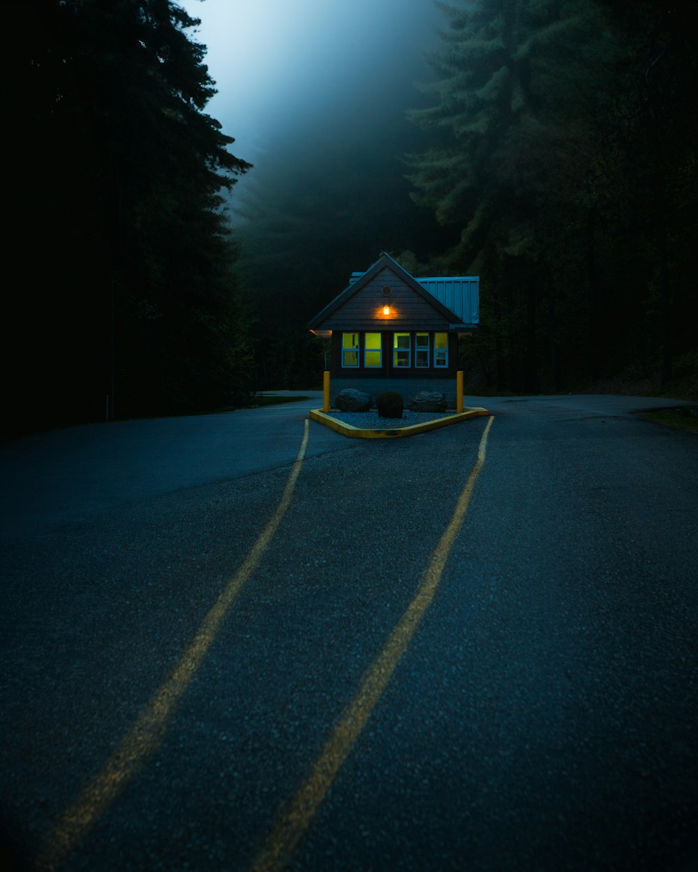 a small house sitting on the side of a road