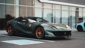 a grey sports car parked in front of a building
