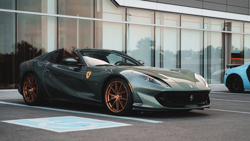 a grey sports car parked in front of a building