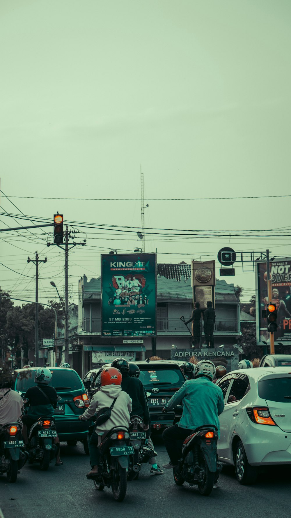 a group of people riding motorcycles down a street