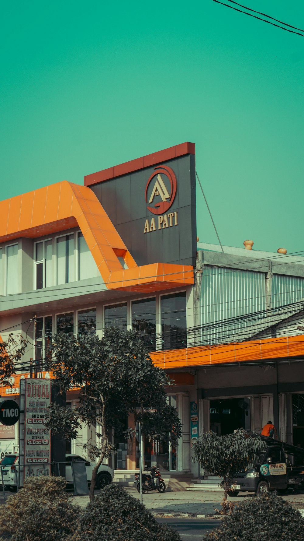 a building with an orange roof and a sign on the front of it